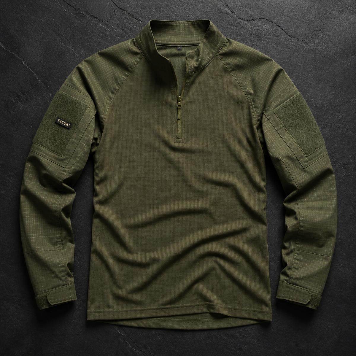 Olive TASINO tactical combat shirt laid flat on dark slate